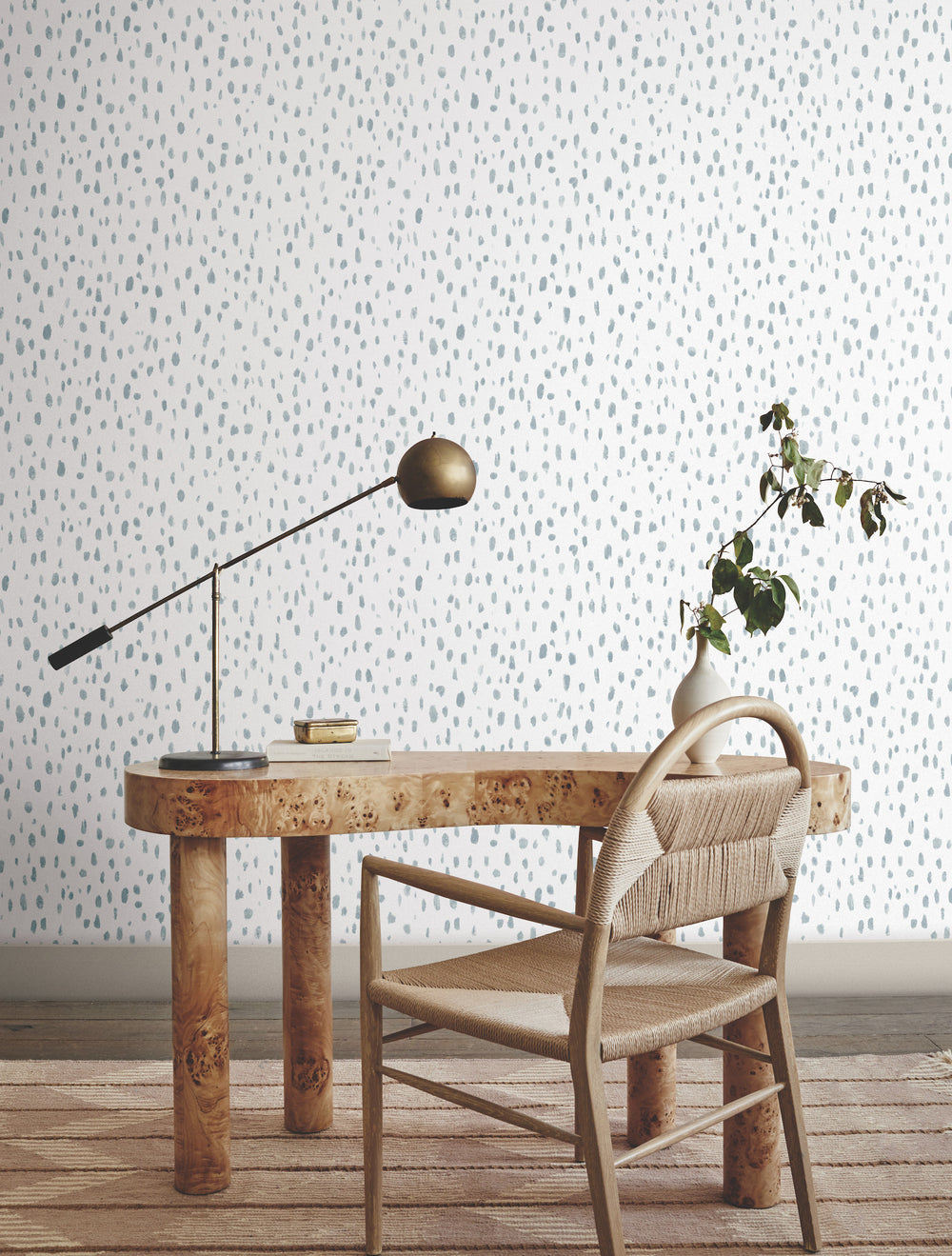 Lemieux et Cie Edition Mural in misty grey and beige, painterly brushstroke wallpaper styled behind a burled wood desk and woven chair on wood flooring.