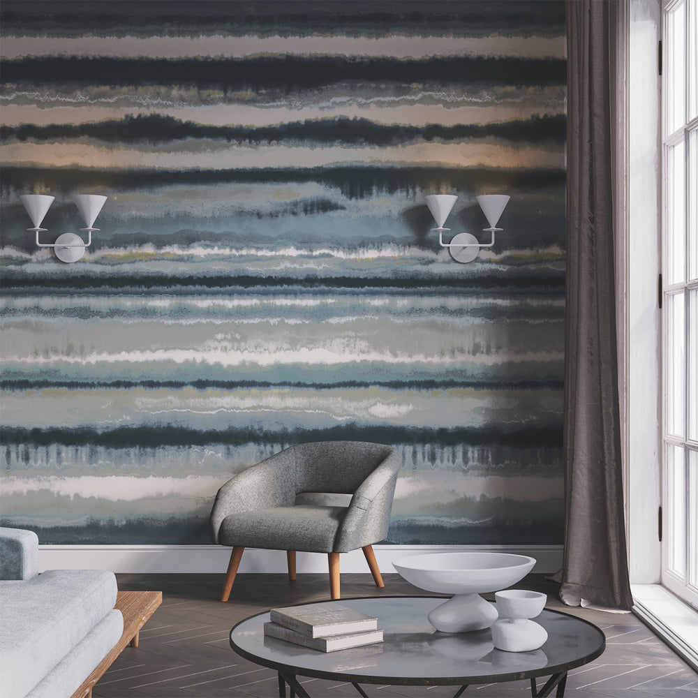 Lemieux et Cie Edition Mural in misty grey and beige, painterly horizontal brushstroke wallcovering, shown behind a sitting room with wood floors and white window trim.