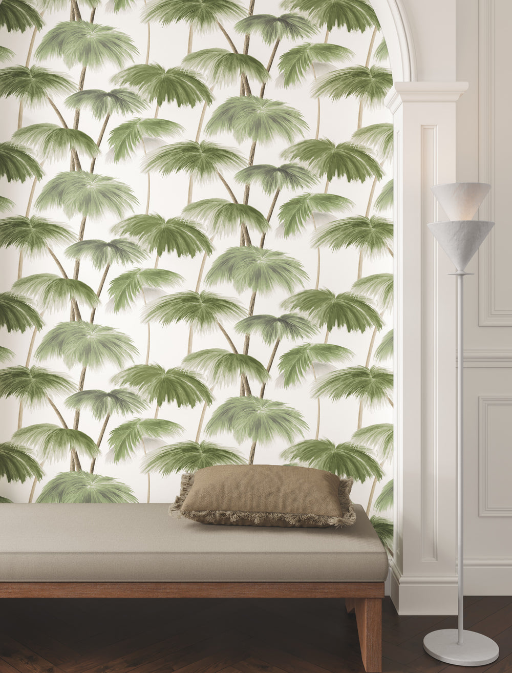 Lemieux et Cie Plein Air Palms wallpaper in green on white, botanical pattern styled in room with white paneled walls, gray upholstered bench and wood flooring.