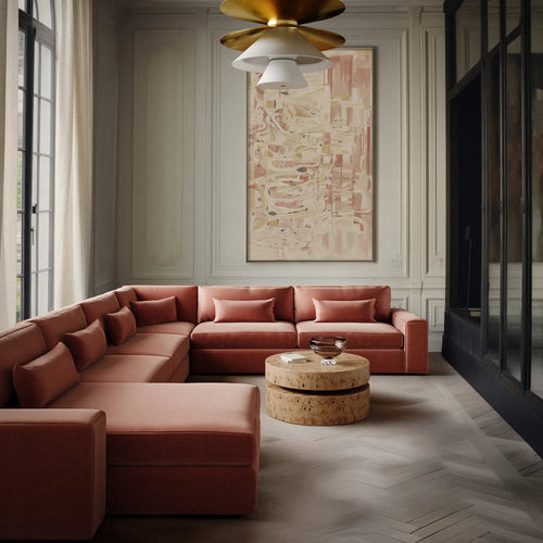 Lemieux et Cie Lacroix U-Sectional in terracotta, modular sofa styled in paneled sitting room with herringbone wood floors and soft daylight.