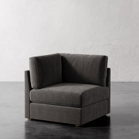 Lemieux Et Cie Chanaux Corner Chair Gray corner sofa against a white wall