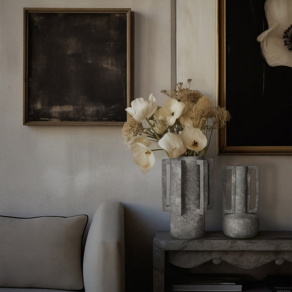Lemieux et Cie Normandie Vase in light grey with geometric square handles, sculptural ceramic vessel styled on stone console with framed art in neutral sitting room.