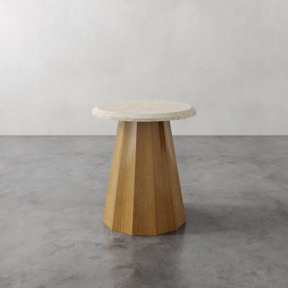 Lemieux et Cie Ondara Fluted Side Table with marble top and geometric base, shown on concrete floor against neutral plaster wall.