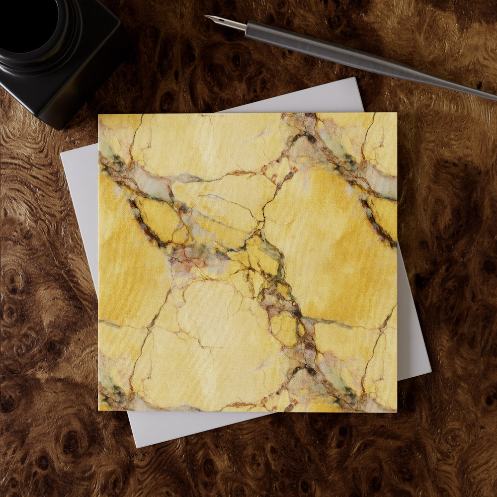 Lemieux et Cie Oro Calcutta Greeting Card Set, yellow marbled greeting card with veining, shown on burl wood surface with pen and envelope.