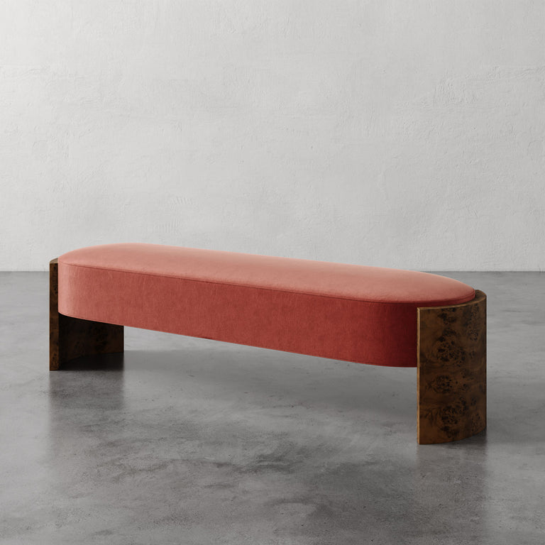 Lemieux et Cie Benoit Custom Upholstered Bench in coral velvet with curved Maple burl legs, low-profile bench on polished concrete floor.