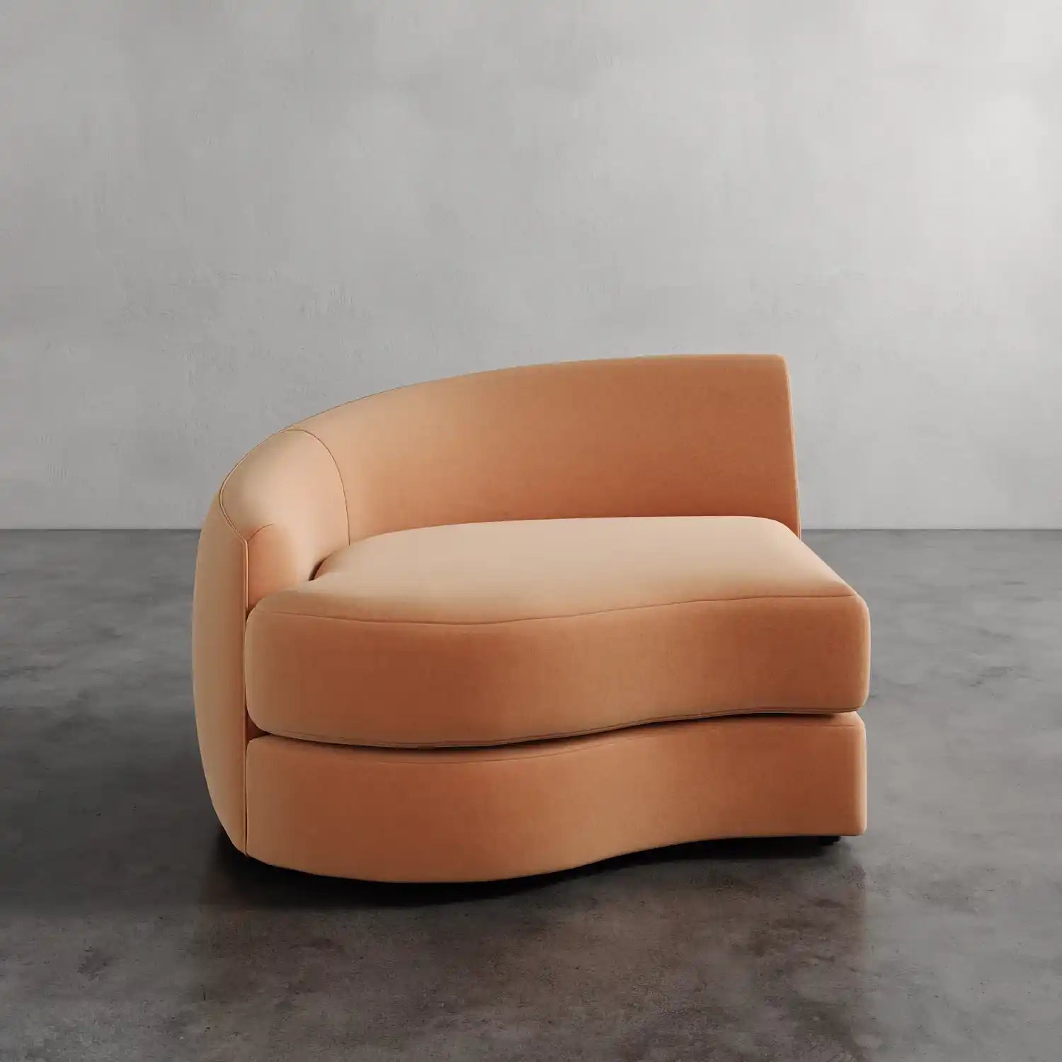 Lemieux Et Cie Rulmann Left Arm Chair  Orange curved sofa on a gray floor with a neutral background