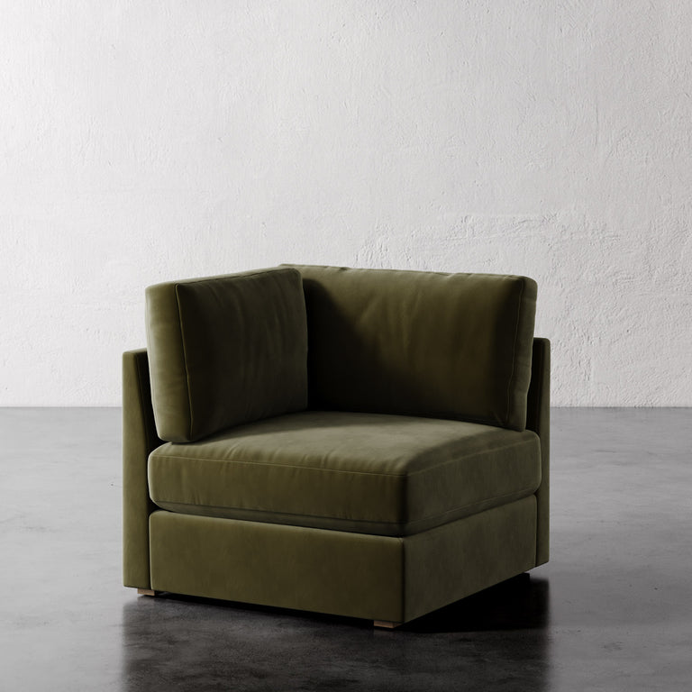 Lemieux Et Cie Chanaux Corner Chair 
 Green corner sofa against a white wall