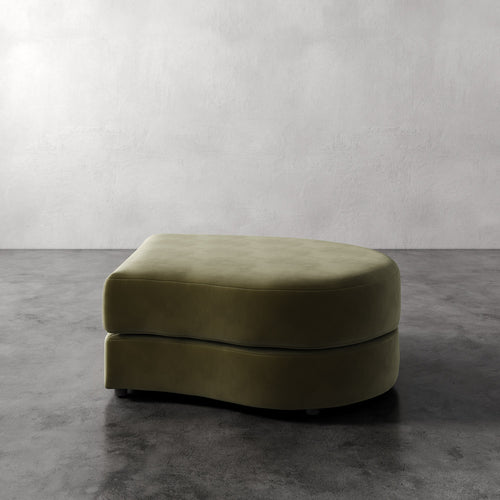 Lemieux Et Cie Rulmann Right Ottoman Green ottoman on a gray floor with a plain white wall background