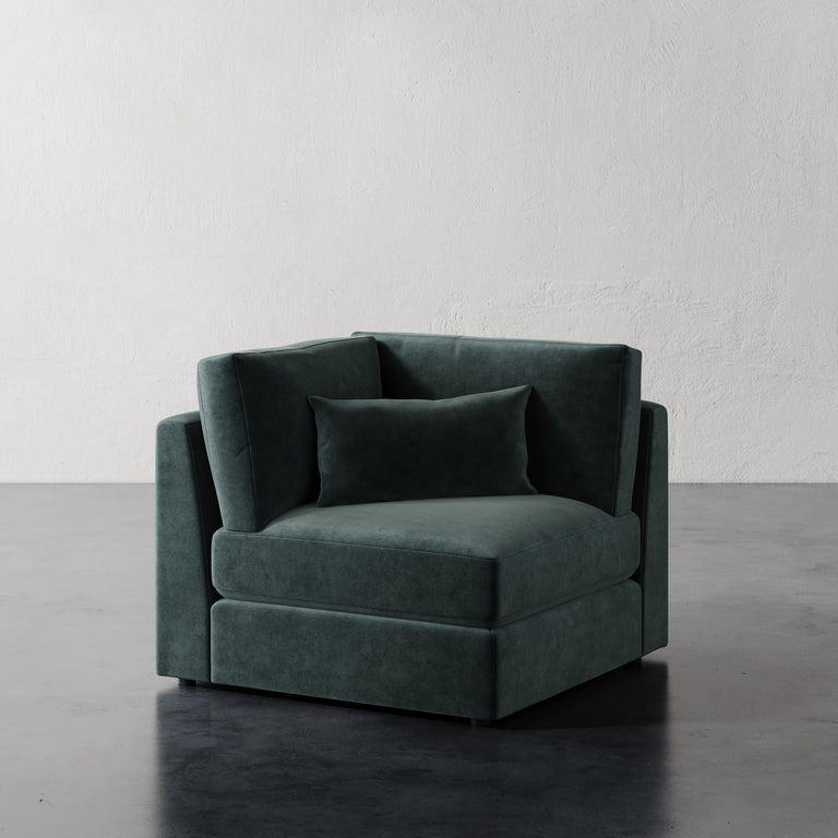 Lemieux Et Cie Lacroix Corner Chair Dark Teal velvet chair against a plain white wall.