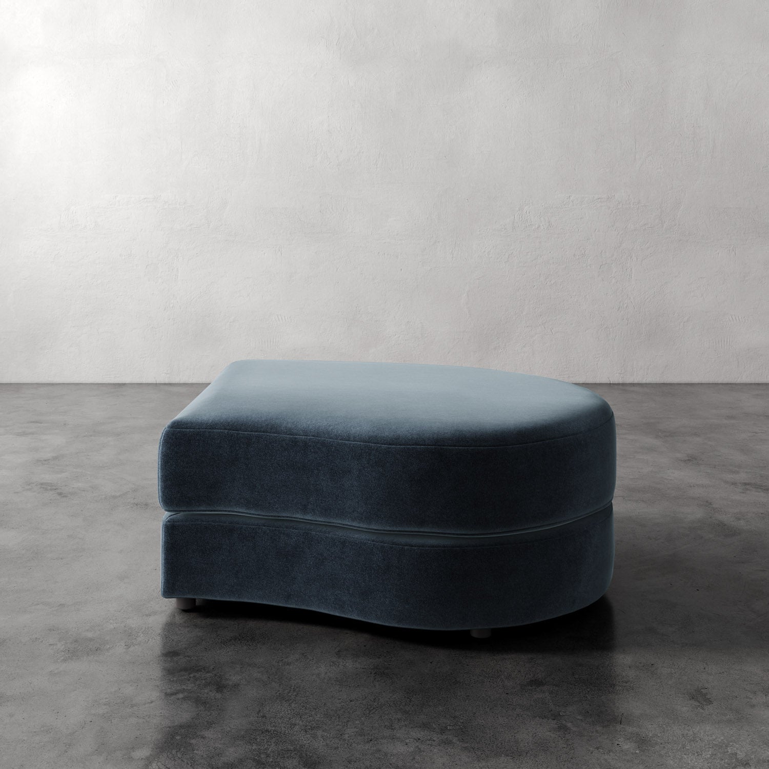 Lemieux Et Cie Rulmann Right Ottoman Blue ottoman on a gray floor with a white wall background