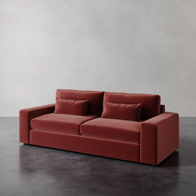 Lemieux Et Cie Lacroix Sofa Red velvet sofa against a plain white wall.