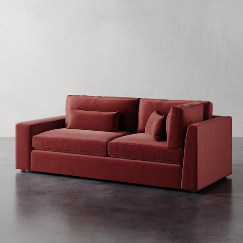 Lemieux Et Cie Lacroix Left or Right Return Sofa Red sofa with cushions on a gray floor and white wall