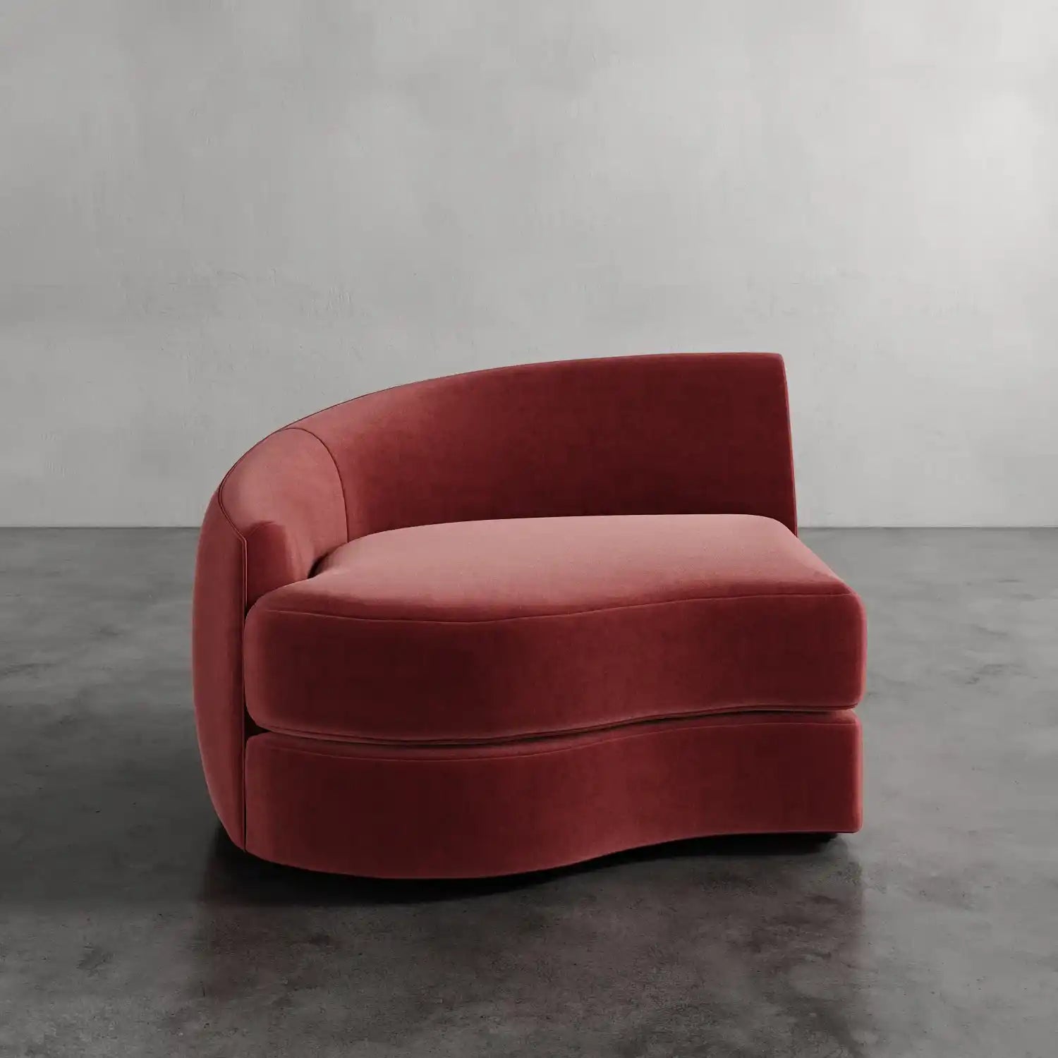 Lemieux Et Cie Rulmann Left Arm Chair Red velvet sofa on a gray floor with a plain wall background