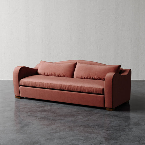 Lemieux Et Cie  Elodie Sofa - Bench Seat (Made-to-order) Pink sofa on a gray floor with a white wall background