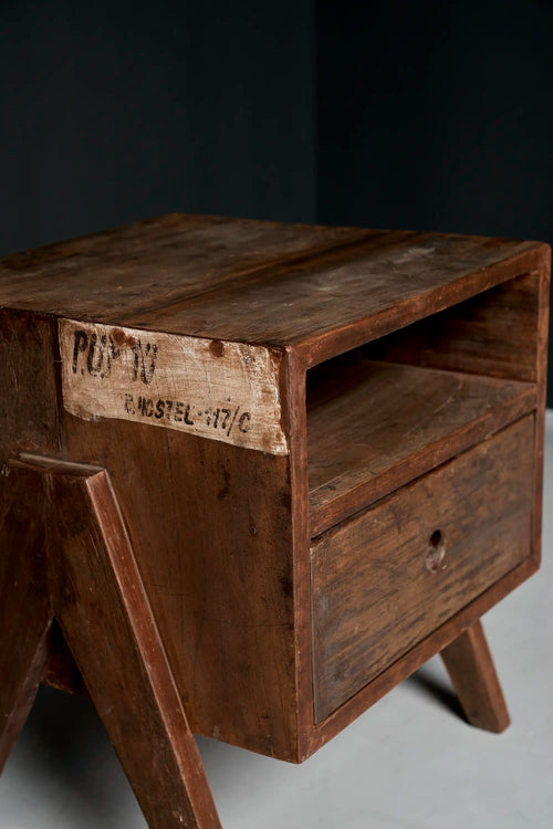 Lemieux et Cie Pierre Jeanneret bedside table in solid teak - three-quarter view showing the open shelf and the P.U.P.10 / B. HOSTEL 117/C stencil