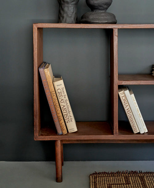 Lemieux et Cie Pierre Jeanneret bookcase in solid teak - styled view of the right-hand open shelves of differing heights with books and ceramic vessels
