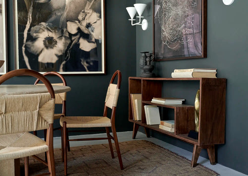 Lemieux et Cie Pierre Jeanneret bookcase in solid teak - wide styled room scene with chairs and framed art, the bookcase styled with books