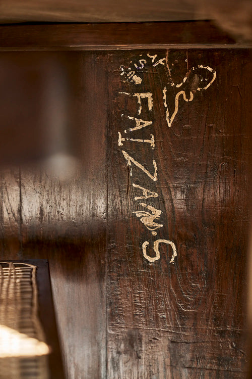 Lemieux et Cie Pierre Jeanneret library table in solid teak - close-up of an original hand-scratched student inscription on the solid teak panel leg