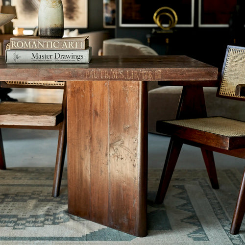 Lemieux et Cie Pierre Jeanneret library table in solid teak - panel-leg end styled with books against a gallery wall