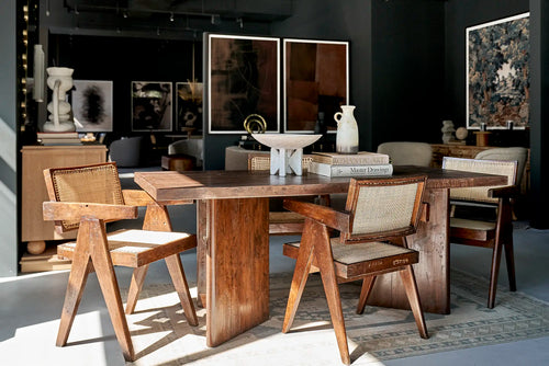 Lemieux et Cie Pierre Jeanneret library table in solid teak - styled table setting with chairs and a gallery wall