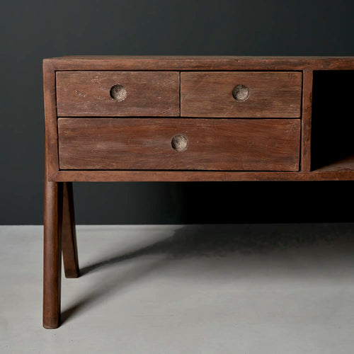 Lemieux et Cie Pierre Jeanneret pedestal unit in solid teak - front three-quarter view of the three drawers with circular cutout pulls on compass A-frame legs