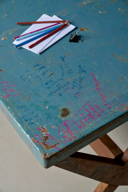 Lemieux et Cie Pierre Jeanneret X-leg student desk with original blue painted top - angled view of the blue painted top styled with printed cards