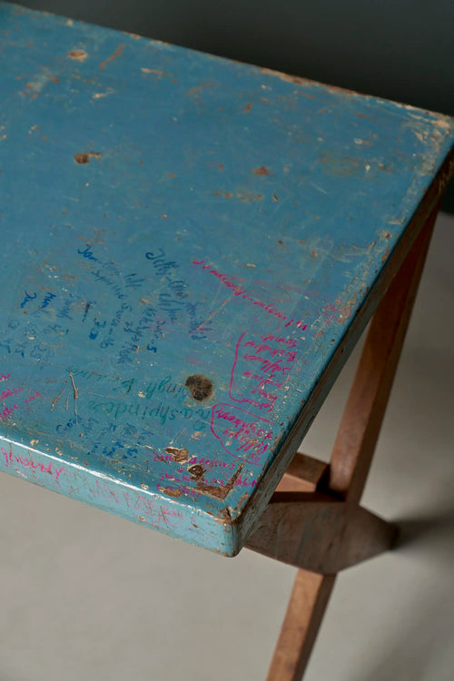 Lemieux et Cie Pierre Jeanneret X-leg student desk with original blue painted top - angled view of the blue painted top with student inscriptions