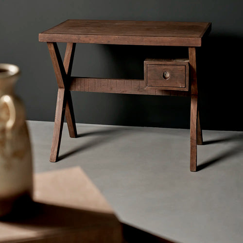 Lemieux et Cie Pierre Jeanneret writing desk in solid teak - side three-quarter studio view showing the X-leg frame, the rail and the drawer