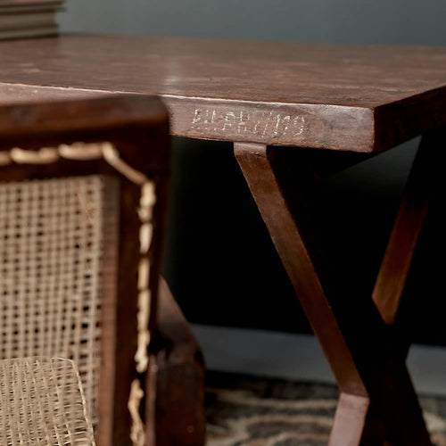 Lemieux et Cie Pierre Jeanneret writing desk in solid teak - styled close-up of the X-leg end with the PU/PHY/119 stencil