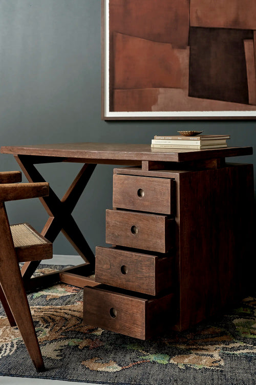 Lemieux et Cie Pierre Jeanneret writing desk in solid teak - styled view from the X-leg side with a teak armchair