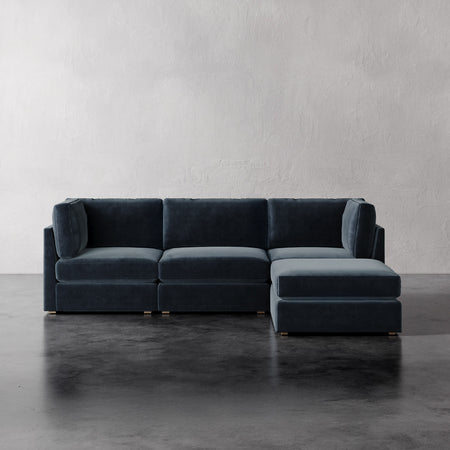  Lemieux Et Cie Chanaux 4-Pc Sectional Gray sectional sofa on a concrete floor with a plain white wall background