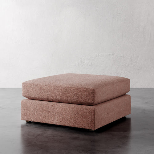 Lemieux Et Cie Chanaux Ottoman Pink ottoman on a gray floor with a white wall background
