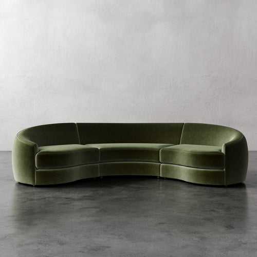 Lemieux Et Cie Rulmann Rulmann 3-Piece Sectional Green curved sofa on a gray floor with a plain wall background