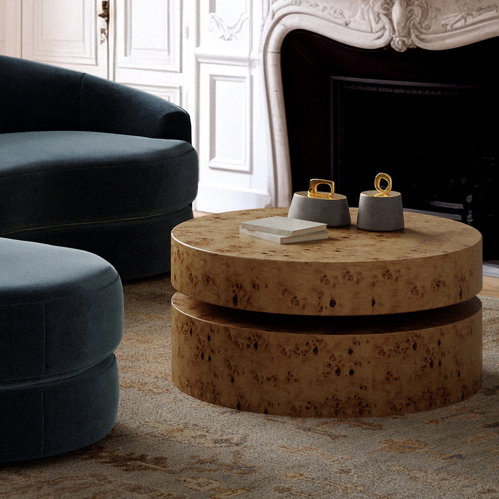 Lemieux et Cie Bocal Lidded Pot in Graffito Marble, ceramic vessel with brass loop handle, styled on tiered coffee table beside dark sofa in white-paneled room.