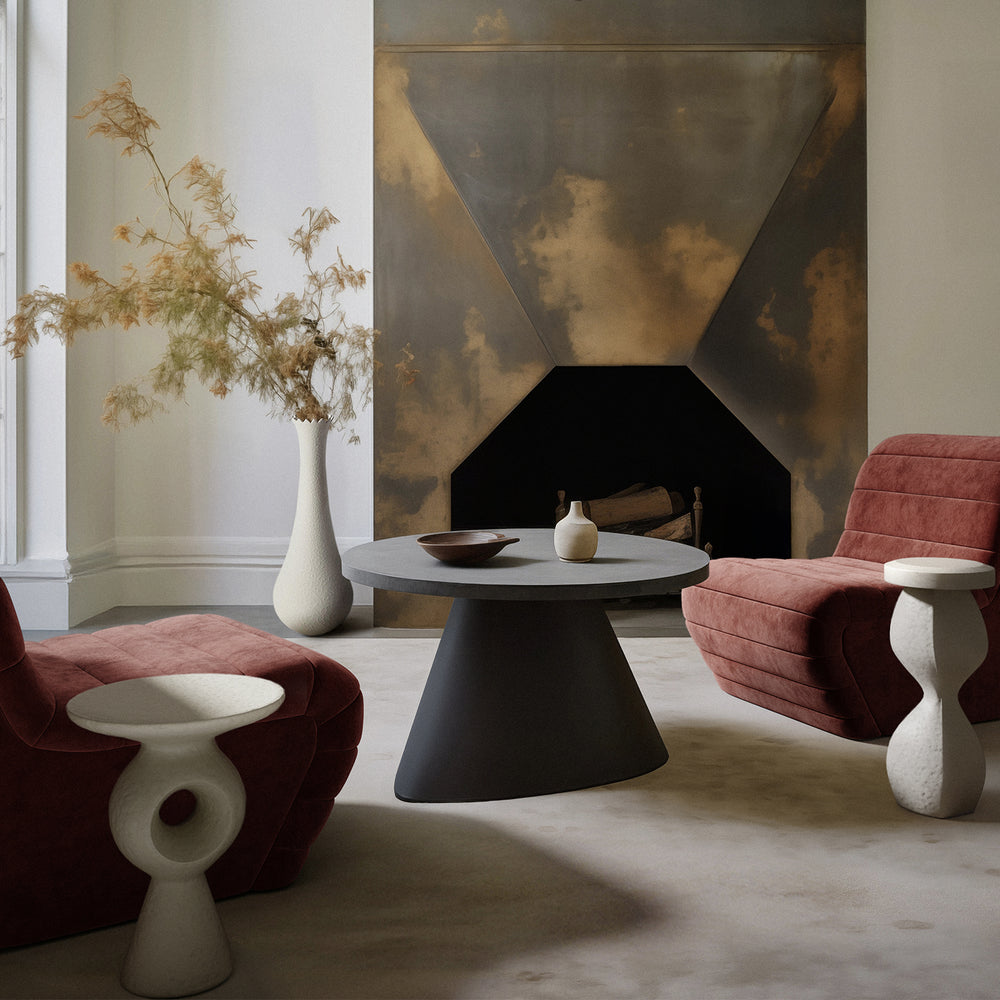 Lemieux et Cie Souple Plaster Drinks Table, sculptural side table with organic undulating form, flanking blush channel-tufted chairs in a sitting room with aged patinated fireplace surround.
