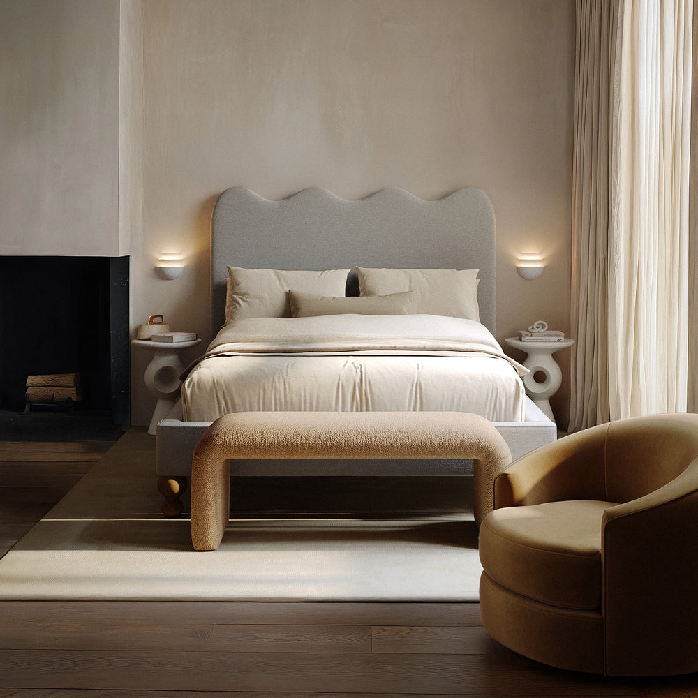 Lemieux et Cie Rulmann Swivel Chair in warm tan, sculptural rounded form, shown in neutral bedroom with wood floors and warm light