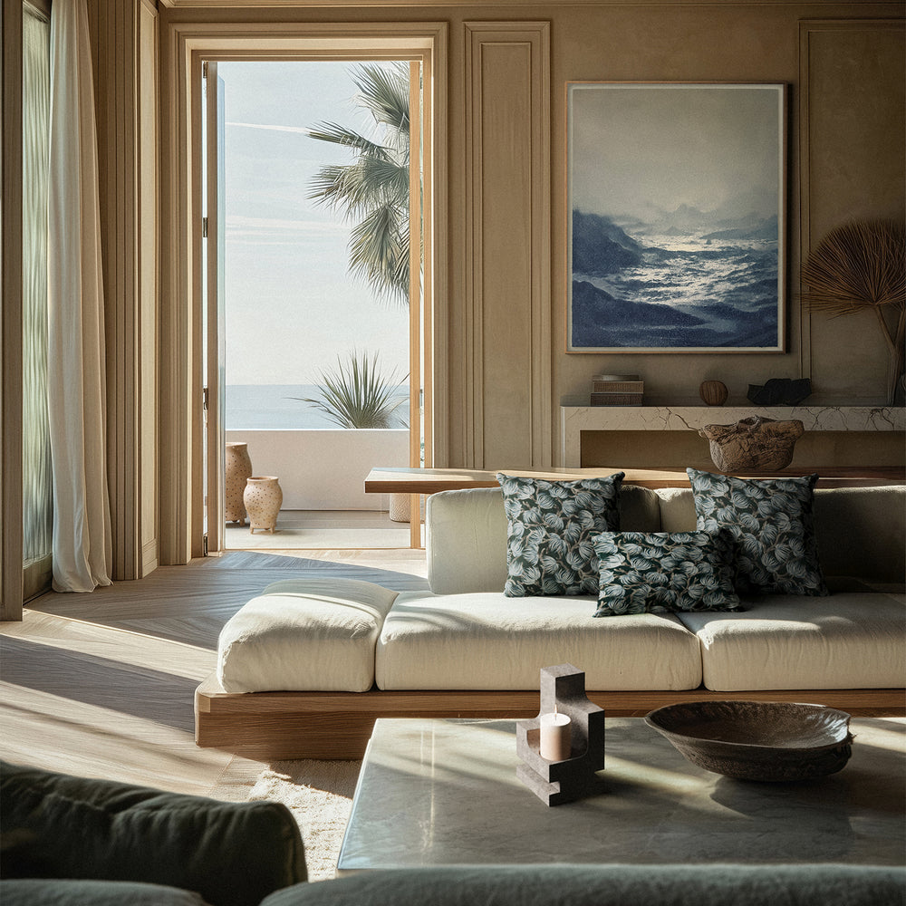 Lemieux et Cie La Structure Sculptural Pillar Holder in grey, geometric candleholder shown in a wood-paneled coastal sitting room with stone floors and warm daylight.