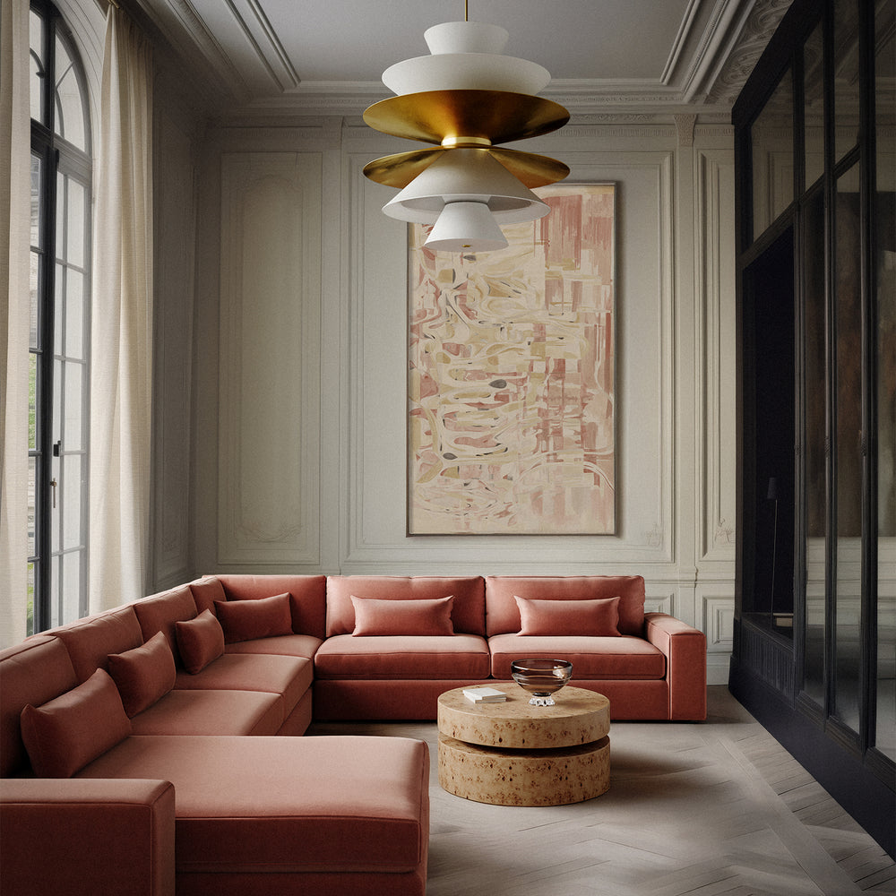 Lemieux et Cie Avenir Coffee Table, sculptural rounded form coffee table in warm stone, shown in a sitting room with terracotta sectional and wood floors.