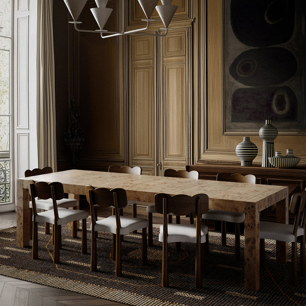 Lemieux et Cie Avenir Dresser in Mappa Burl with hand-cast brass hardware, six-drawer dresser in warm neutral dining room with wood-paneled walls and textured rug.