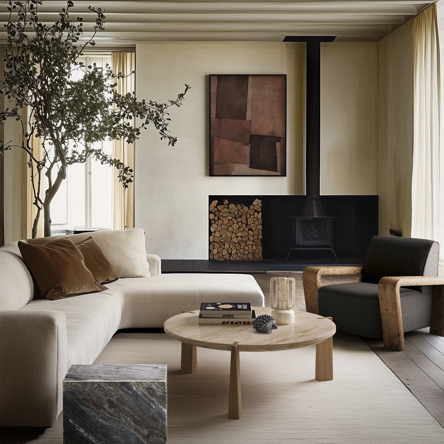 Lemieux et Cie Le Havre Limited Edition Art Print in cinnamon, blush and taupe, geometric abstract artwork, displayed above a wood-burning stove in a neutral living room with beamed ceiling.