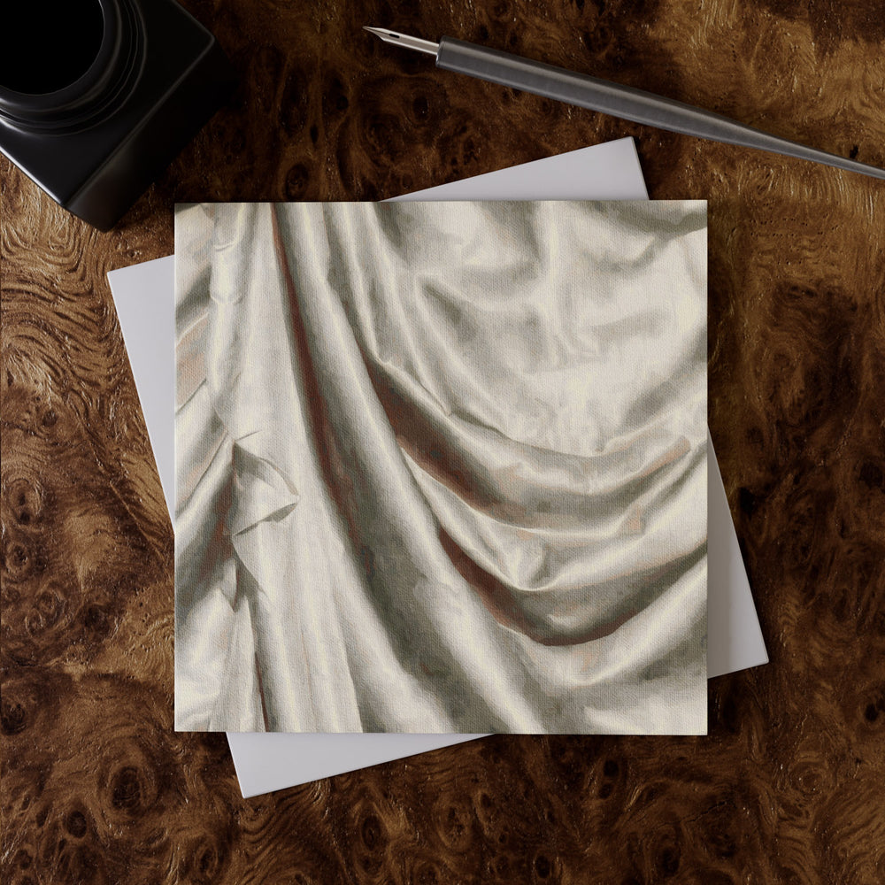 Lemieux et Cie Satin Drape Greeting Card, fine art linen paper with soft draped folds, placed on burl wood surface with envelope and pen