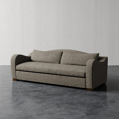 Lemieux Et Cie Elodie Sofa - Bench Seat (Made-to-order) Gray sofa on a gray floor with a white wall background
