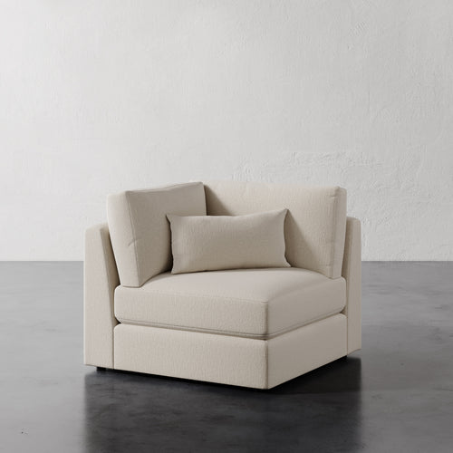 Lemieux Et Cie Lacroix Corner Chair Off-White velvet chair against a plain white wall.