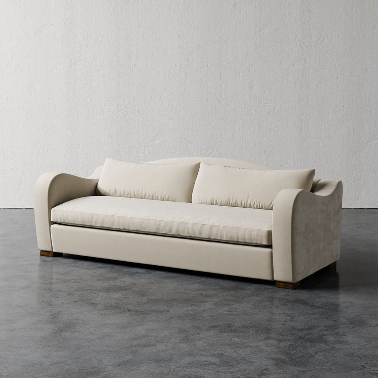 Lemieux Et Cie Elodie Sofa - Bench Seat (Made-to-order) Beige sofa on a gray floor with a plain white wall background