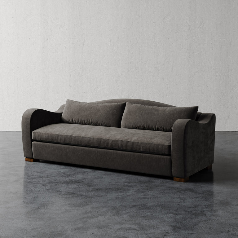 Lemieux Et Cie Elodie Sofa - Bench Seat (Made-to-order) Gray sofa on a dark floor with a light gray wall background