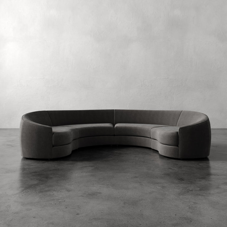 Lemieux Et Cie Rulmann 4-Piece Sectional   Modern gray sectional sofa on a concrete floor with a plain wall background