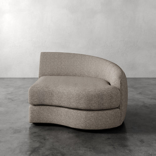 Lemieux Et Cie Rulmann Right Arm Chair Modern beige armchair on a gray floor with a plain wall background