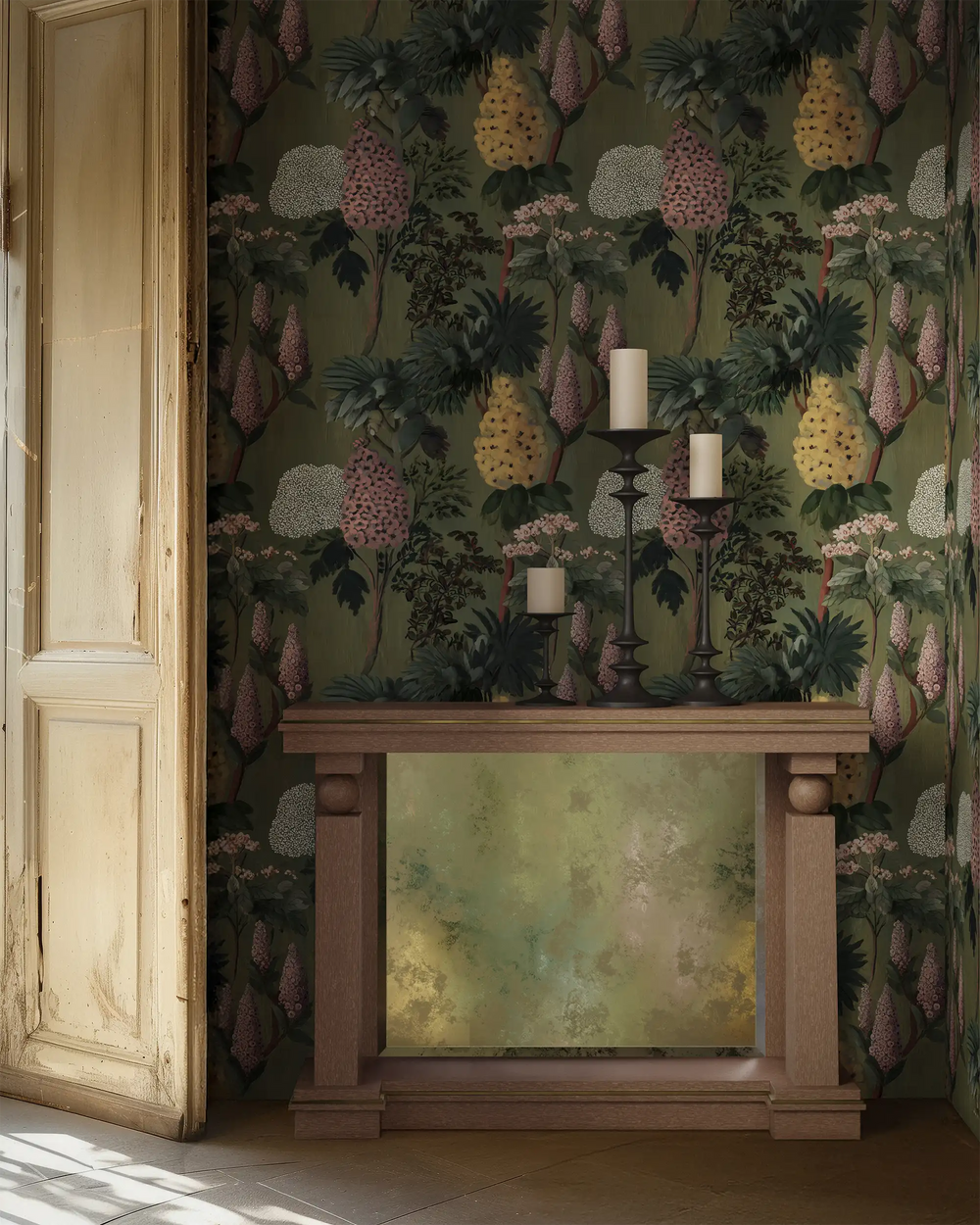Lemieux et Cie Winsome Garden Wallpaper in soft green with large-scale florals in earthy tones, chinoiserie wallpaper shown behind a wood mantel in a sunlit room with aged paneled door.