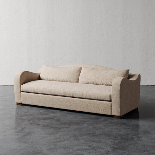 Lemieux Et Cie Elodie Sofa - Bench Seat (Made-to-order) Beige sofa on a gray floor with a plain white wall background