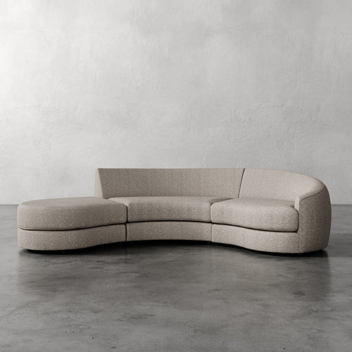 Lemieux Et Cie Rulmann 3-Piece Right Sectional  Curved beige sofa against a plain gray wall